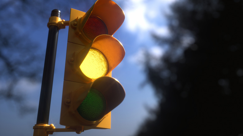 A yellow traffic light displaying a flashing or solid yellow.