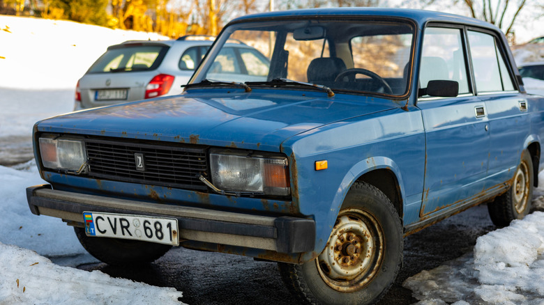 A rusty Lada 2105 in snowy and icy conditions