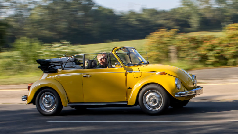 A side shot of a 1975 Volkswagen Beetle Convertible in yellow