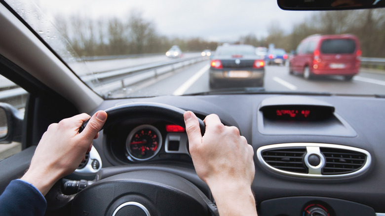 A driver's view from the windshield while on the highway in the left lane.
