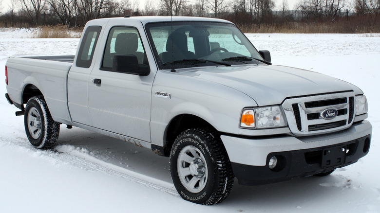 A silver 2011 Ford Ranger XLT sitting in a snowy field.