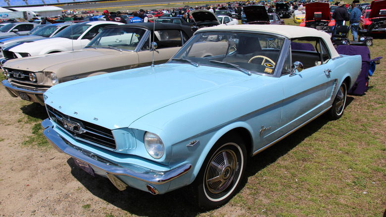 A light blue 1964 Ford Mustang in the infield at Charlotte Motor Speedway