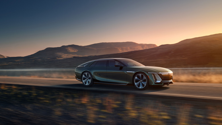 The enlongated-looking Cadillac Celestiq EV from the passenger's side, driving along a desert mountain road at dusk.