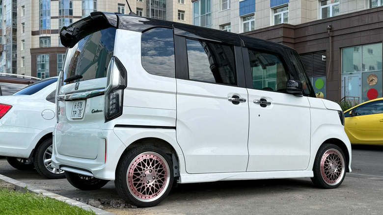 A modified white Honda n-one in a parking spot.