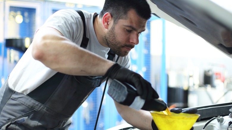 Mechanic changing oil