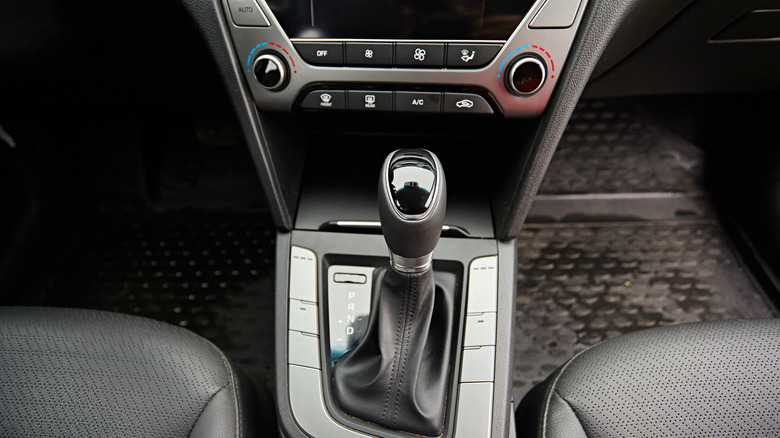 A close-up of an automatic car transmission lever.
