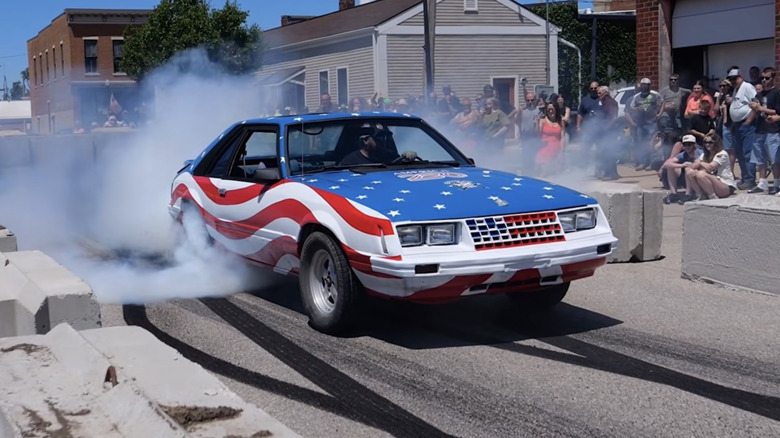 1979 Ford Mustang painted like an American flag doing a burnout