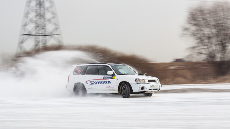 Moscow, Russia - march 1, 2014: Car on ice in motion. Driving subarus on frozen pond.