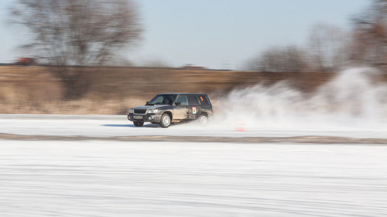 Moscow, Russia - march 1, 2014: Car on ice in motion. Driving subarus on frozen pond.