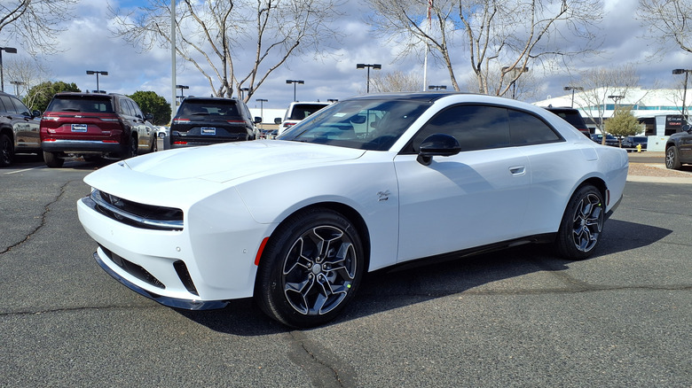 A white 2024 Dodge Charger Daytona R/T parking in a dealership lot
