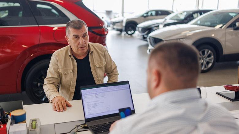 Car dealer on computer