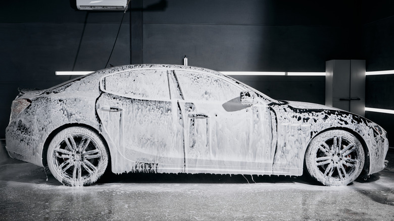 A car covered in soap during a car wash.