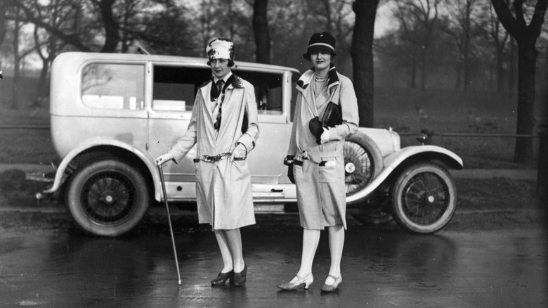 6th January 1927: A couple of ladies wearing fashionable white mackintoshe's in Hyde Park, London.