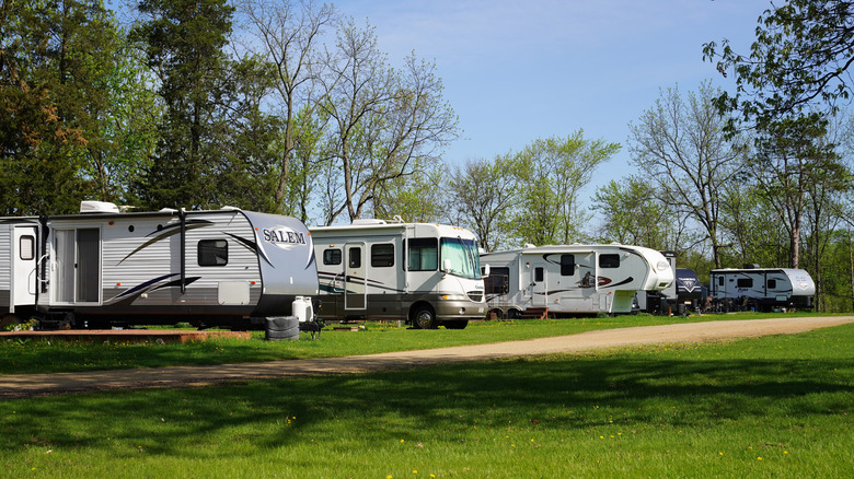 Travel trailers and a motorhome parked at campgrouds