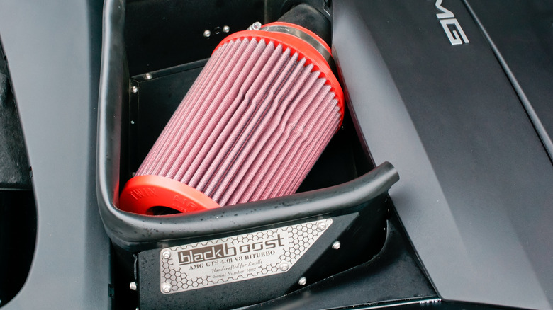 An aftermarket cold air intake system in the engine bay of a Mercedes-AMG car with a 4.0-liter V8 motor