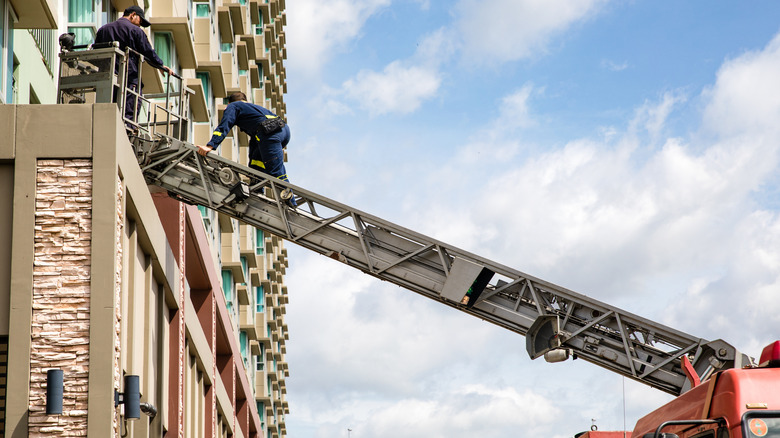 Firefighters using an aerial ladder
