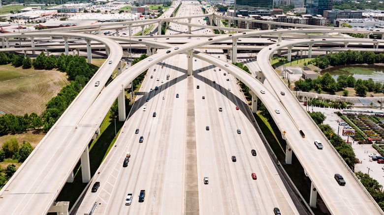 An aerial shot of a network of freeways with lots of moving traffic.