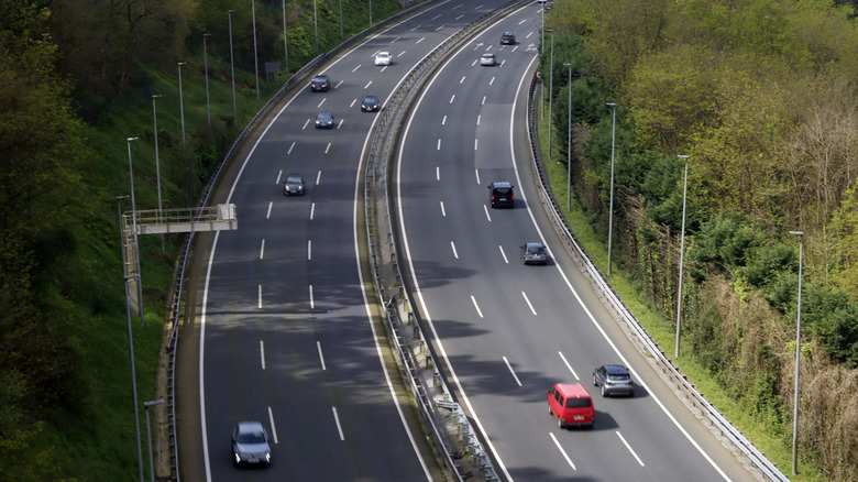 An aerial shot of a highway with light flowing traffic.
