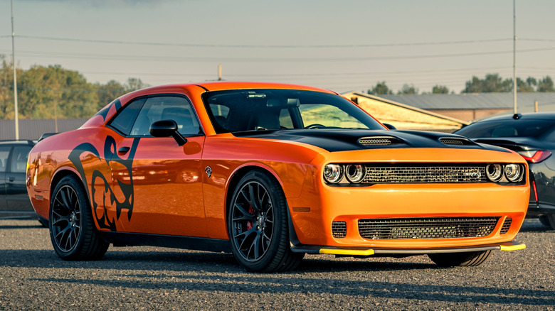 An orange Dodge Challenger Hellcat parked outside