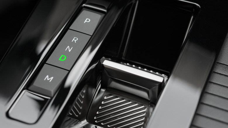 An automatic transmission gear selector with Drive engaged.