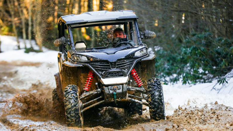 A UTV being used off-road in a snowy area
