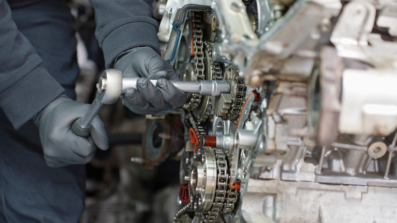 Close up of mechanic tightening a bolt on a car engine
