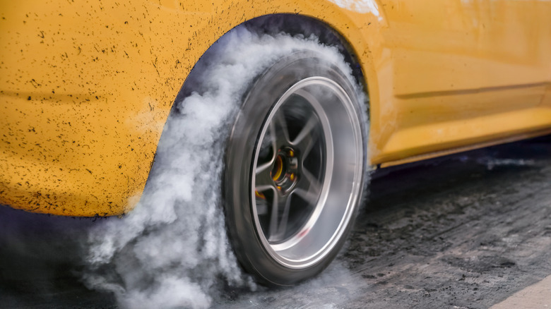 A drag racing car burning rubber