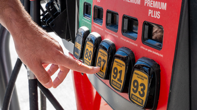 Making a selection at an American gasoline pump, featuring 91 and 93 octane premium fuel.