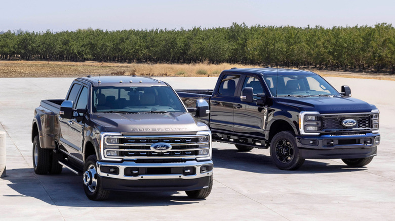 Two of Ford's Super Duty pickups from 2023 parked side-by-side.