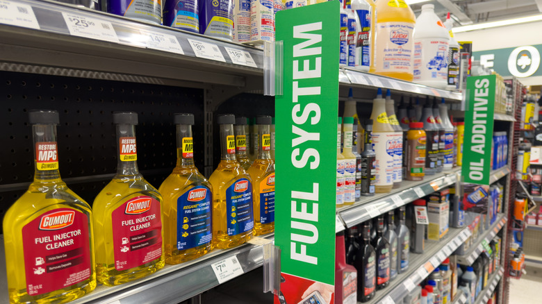 A variety of fuel treatment and stabilizer products display in an automotive store