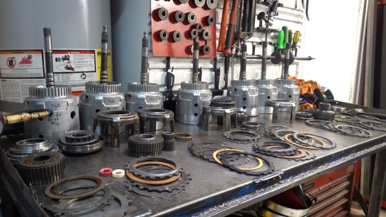 A workbench display of automatic transmission parts.