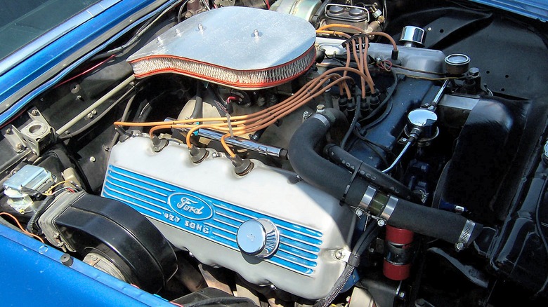 A Ford 427 FE SOHC Cammer V8 under the hood of a blue Ford Thunderbird