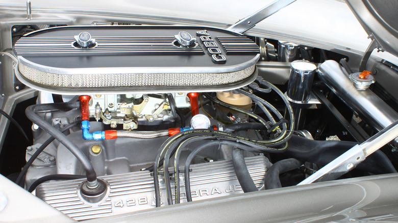 A Ford 428 FE Cobra Jet V8 under the hood of a silver car