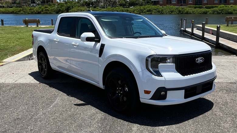 A white Ford Maverick Lobo parked in front of a boat ramp.