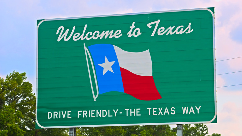 Texas welcome sign coming from the east on Interstate 10 with colored clouds