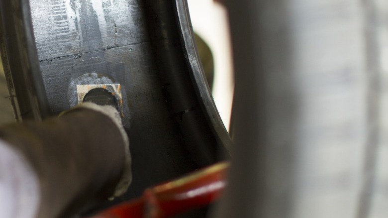 A mechanic patching tire from the inside