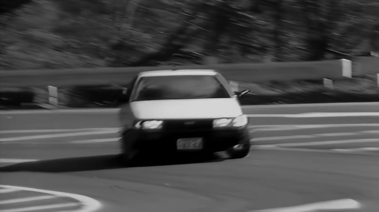 A white Toyota AE86 slides through a corner
