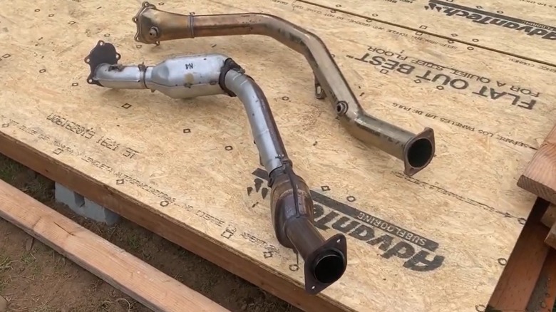 A catted downpipe lying next to a catless downpipe