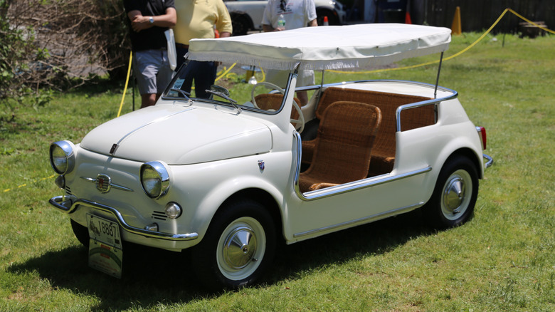 A white 1961 Fiat 500 Jolly on a lawn