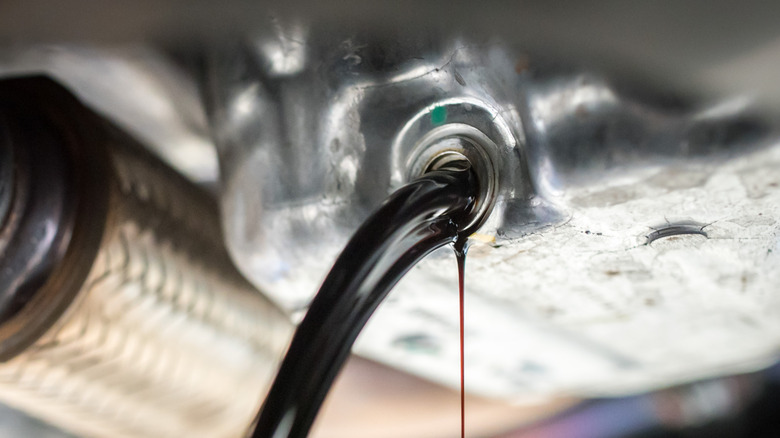 Oil draining from a car engine with a steel oil pan