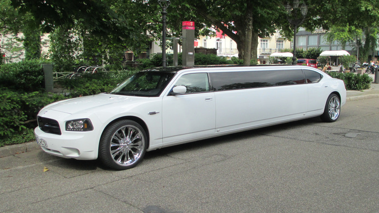 A white Dodge Charger limo on a street in Germany