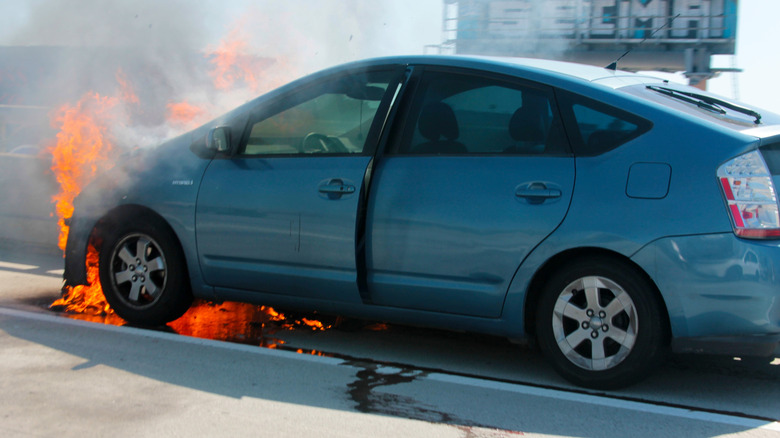 USA - March 12, 2025: Car Fire. Toyota Prius Electric vehicle on Fire on the I-5 Freeway in Los Angeles, California. Burning car close up. Big flames of fire and smoke. Fire