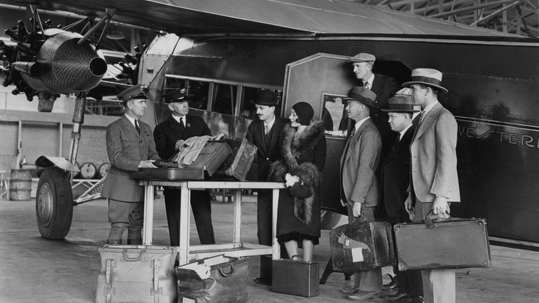 UNITED STATES - CIRCA 1930: Passengers of a plane from Mexico to Los Angeles. Customs control in front of the plane. Photograph. Around 1930.