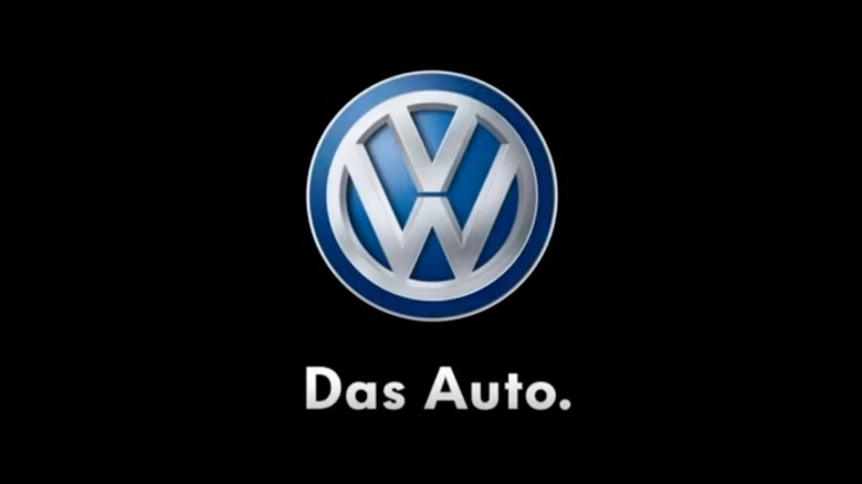 screenshot from a video showing the VW logo in front of a black background with the words"Das Auto" in white below