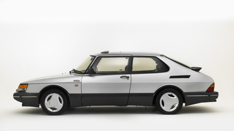 a saab 900 turbo in silver against a white background