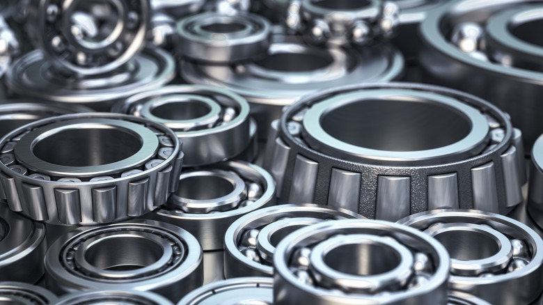 A pile of roller and ball bearing wheel bearings