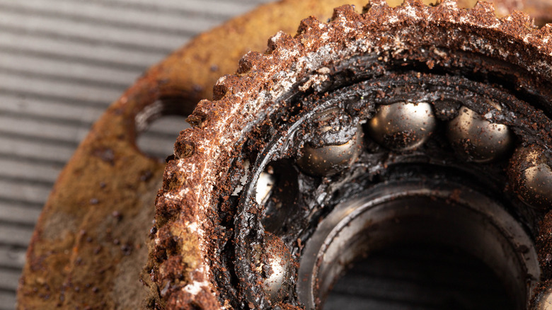 A closeup of a rusted, broken wheel bearing