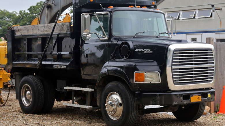 Front and side shot of a black 1995 Ford Aeromax L9000 truck