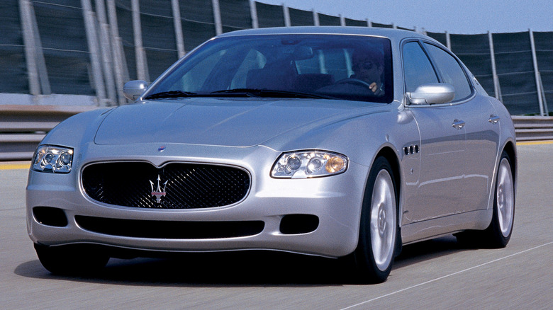 A silver 2003 Maserati Quattroporte driving on the road