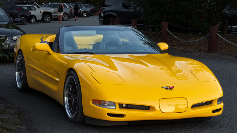 Yellow fifth-generation Chevrolet Corvette parked outside with its top down